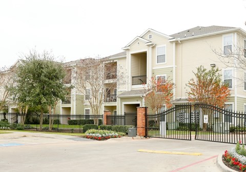 a row of townhouses with a fence in front of them